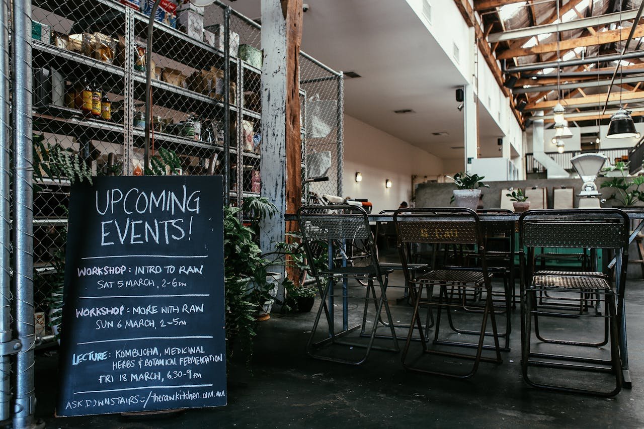 Urban event space featuring a chalkboard with upcoming workshops in a stylish setting.